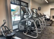 Thumbnail 7 of 12 - a row of treadmills and elliptical trainers in a gym at 2300 West Apartments, Reno, NV, 89502