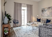 Thumbnail 4 of 35 - Living room with patio access at The Station at River Crossing, Macon, GA