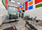 Thumbnail 2 of 25 - a spacious fitness center with cardio equipment and free weights at 670 Thornton, Lithia Springs, Georgia