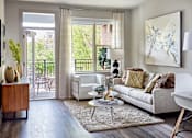 Thumbnail 4 of 39 - A living room with a white couch and a large painting on the wall.
