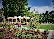 Thumbnail 18 of 39 - A gazebo is surrounded by trees and plants.