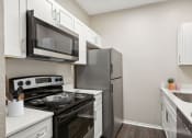 Thumbnail 3 of 14 - the preserve at ballantyne commons apartment kitchen with stainless steel appliances at Canyon Creek, Austin, TX, 78759