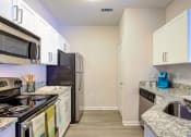 Thumbnail 4 of 14 - a kitchen with stainless steel appliances and granite counter tops at Thornberry Apartments, Charlotte, 28262