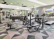Thumbnail 12 of 19 - A gym with a variety of equipment including treadmills, weights, and exercise machines. at Lucie at Tradition Apartments, Port St. Lucie, Florida
