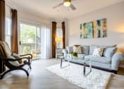 Thumbnail 5 of 14 - a living room with a couch and a glass table at Thornberry Apartments, Charlotte, NC
