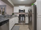 Thumbnail 33 of 43 - Kitchen with stainless steel appliances at Saddleworth Green, Ocala