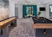 Thumbnail 6 of 43 - A room with a pool table and a tv.
