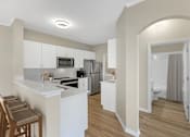 Thumbnail 3 of 29 - Open-Concept Kitchen and bar with stainless steel appliances and modern finishes