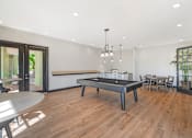 Thumbnail 23 of 29 - A room with a pool table and a dining table.