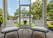 Thumbnail 38 of 38 - Two chairs with white cushions are placed on a patio.