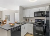 Thumbnail 2 of 35 - Open Concept Kitchen with white cabinets and wood style plank flooring