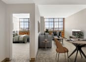 Thumbnail 3 of 35 - A modern living room with an exposed brick wall and a large window.