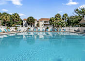 Thumbnail 17 of 30 - A large swimming pool with a blue tinted water.