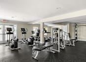 Thumbnail 14 of 30 - A gym with a variety of equipment including weights and cardio machines.
