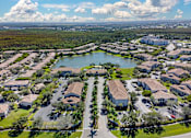 Thumbnail 1 of 32 - A bird's eye view of a residential area with a lake in the middle.