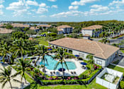 Thumbnail 30 of 32 - A large white building with a pool in front of it.