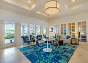 Thumbnail 25 of 32 - A spacious living room with a blue rug and a large window.