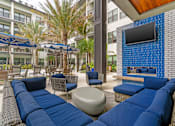Thumbnail 19 of 49 - A blue couch is in the middle of a patio.