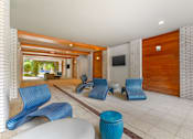 Thumbnail 44 of 49 - A room with blue chairs and a white table.