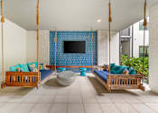 Thumbnail 20 of 49 - A room with a blue screen and two wooden beds.