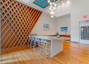 Thumbnail 32 of 49 - A kitchen with a white island and a wine rack.