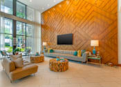 Thumbnail 29 of 49 - A living room with a wooden wall and a flat screen TV.