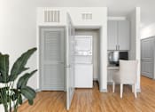 Thumbnail 14 of 49 - A white chair is in front of a small kitchen.