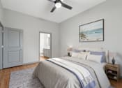 Thumbnail 4 of 49 - A bedroom with a large bed and a ceiling fan.