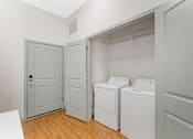 Thumbnail 8 of 49 - A laundry room with a washer and dryer.