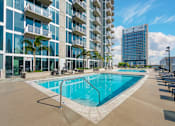 Thumbnail 20 of 48 - A large swimming pool in front of a modern building.