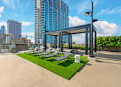 Thumbnail 21 of 48 - A modern outdoor seating area with a glass wall and a metal frame.