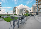 Thumbnail 25 of 48 - A patio with a table and chairs overlooks a cityscape.