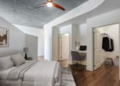Thumbnail 3 of 48 - A bedroom with a large bed and a desk with a chair.