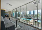Thumbnail 36 of 48 - A modern living room with a pool outside the window.