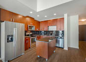 Thumbnail 13 of 48 - A kitchen with wooden cabinets and stainless steel appliances