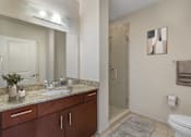 Thumbnail 14 of 48 - A bathroom with a sink, toilet, and shower.