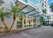 Thumbnail 42 of 48 - Entrance to Element Apartments surrounded by a side walk and palm trees
