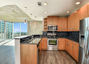 Thumbnail 10 of 27 - A modern kitchen with wooden cabinets and stainless steel appliances. at Element, Tampa, Florida