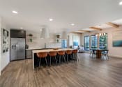 Thumbnail 27 of 49 - A modern kitchen with a dining table and chairs.