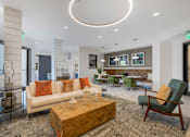 Thumbnail 33 of 49 - A living room with a white couch and a wooden coffee table.