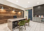 Thumbnail 35 of 49 - A modern kitchen with a wooden wall and a marble table.