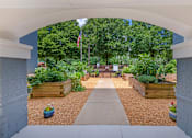 Thumbnail 22 of 49 - A garden with a flag and a walkway.