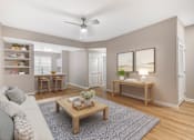 Thumbnail 6 of 49 - A living room with a couch, a coffee table, and a ceiling fan.