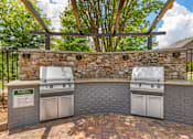 Thumbnail 19 of 49 - A stone wall with two grills on top.