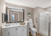 Thumbnail 5 of 49 - A bathroom with a white toilet, sink, and mirror.