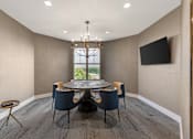 Thumbnail 40 of 49 - A modern dining room with a round table and chairs.