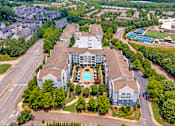 Thumbnail 45 of 49 - A large building with a pool in the middle of it.
