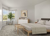 Thumbnail 9 of 34 - A bedroom with a large bed, a nightstand, and a small table.
