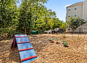 Thumbnail 28 of 34 - A playground with a red and blue slide in the foreground.