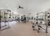 Thumbnail 7 of 33 - A spacious gym with a variety of equipment.
